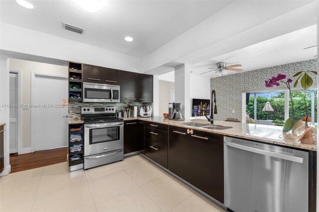 3075 SW 19th St, Miami, FL 33145 - kitchen featuring stainless steel appliances, light stone counters, decorative backsplash, open shelves, and recessed lighting