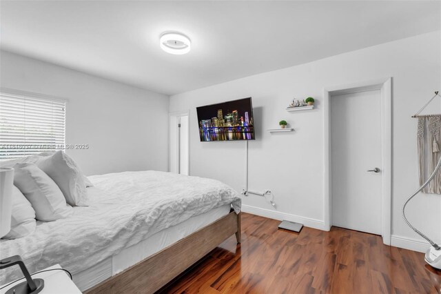 3075 SW 19th St, Miami, FL 33145 - bedroom featuring baseboards and wood finished floors