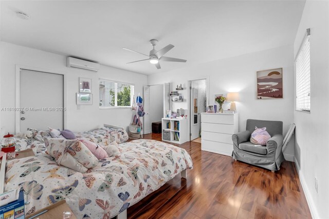 3075 SW 19th St, Miami, FL 33145 - bedroom featuring an AC wall unit, wood finished floors, ceiling fan, and a closet