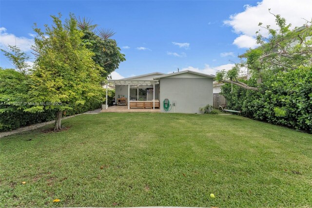 3075 SW 19th St, Miami, FL 33145 - rear view of house featuring stucco siding and a patio