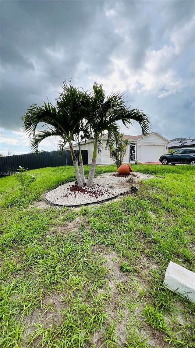 1908 NE 2nd Pl, Cape Coral, FL 33909 - view of yard with a garage