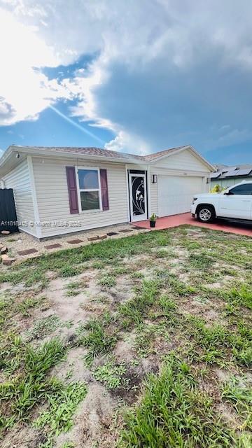 1908 NE 2nd Pl, Cape Coral, FL 33909 - view of front of home featuring an attached garage