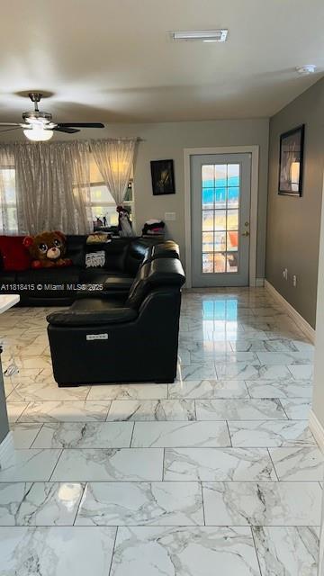 1908 NE 2nd Pl, Cape Coral, FL 33909 - living room featuring marble finish floors and a ceiling fan