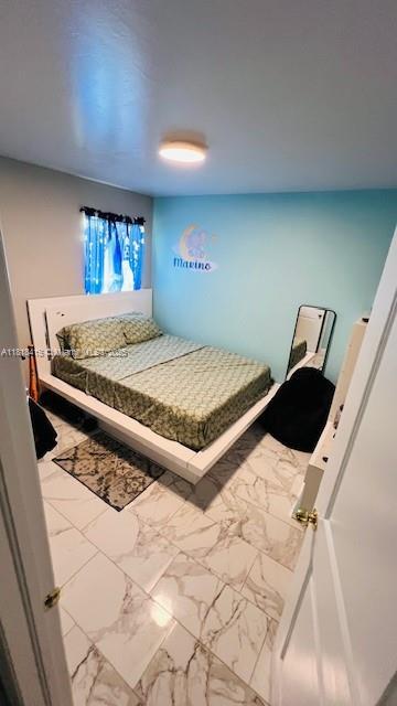 1908 NE 2nd Pl, Cape Coral, FL 33909 - bedroom featuring marble look tile flooring