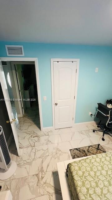 1908 NE 2nd Pl, Cape Coral, FL 33909 - bedroom featuring baseboards and marble finish floors