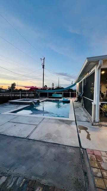 1908 NE 2nd Pl, Cape Coral, FL 33909 - pool at dusk featuring a patio area