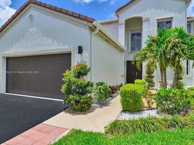 624 Stanton Dr, Weston, FL 33326 - view of front of home featuring stucco siding, driveway, and an attached garage