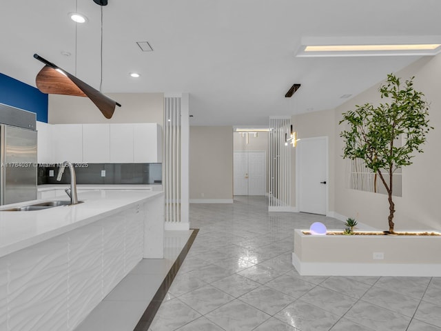 624 Stanton Dr, Weston, FL 33326 - kitchen with stainless steel built in fridge, white cabinetry, light countertops, hanging light fixtures, and modern cabinets
