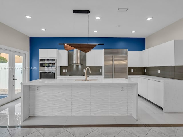 624 Stanton Dr, Weston, FL 33326 - kitchen with stainless steel appliances, modern cabinets, white cabinets, tasteful backsplash, and a large island with sink
