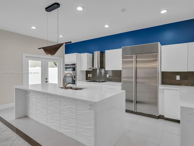 624 Stanton Dr, Weston, FL 33326 - kitchen featuring appliances with stainless steel finishes, wall chimney range hood, modern cabinets, white cabinets, and decorative backsplash