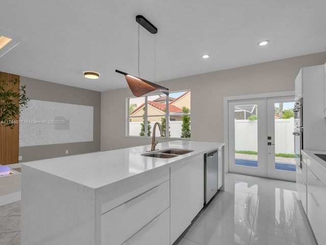 624 Stanton Dr, Weston, FL 33326 - kitchen with stainless steel dishwasher, white cabinets, french doors, and recessed lighting