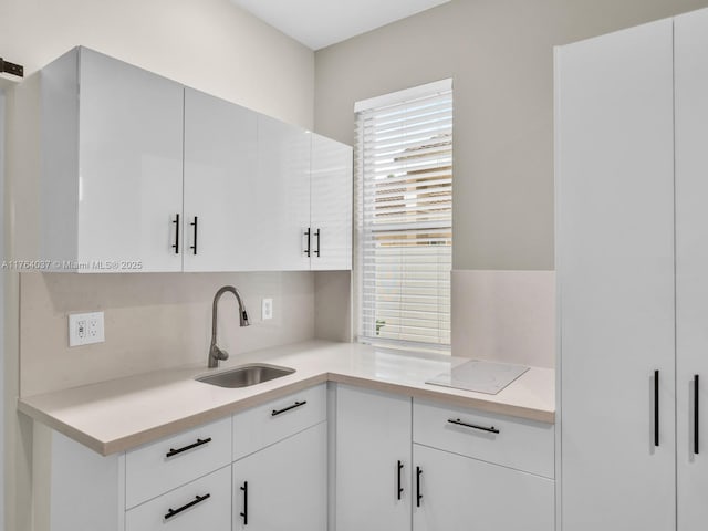 624 Stanton Dr, Weston, FL 33326 - kitchen featuring light countertops, white cabinets, decorative backsplash, and electric cooktop