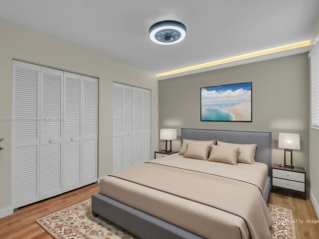 624 Stanton Dr, Weston, FL 33326 - bedroom featuring multiple closets and wood finished floors