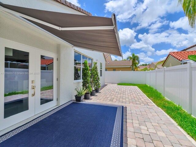 624 Stanton Dr, Weston, FL 33326 - fenced backyard featuring french doors and a patio