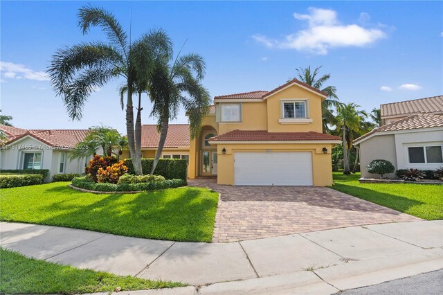 477 Spinnaker, Weston, FL 33326 - mediterranean / spanish-style home featuring a tile roof, stucco siding, decorative driveway, an attached garage, and a front lawn