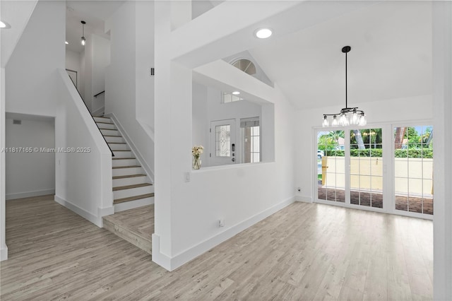 477 Spinnaker, Weston, FL 33326 - unfurnished living room featuring high vaulted ceiling, wood finished floors, baseboards, a chandelier, and recessed lighting
