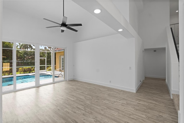 477 Spinnaker, Weston, FL 33326 - unfurnished living room with high vaulted ceiling, ceiling fan, light wood-style flooring, recessed lighting, and baseboards