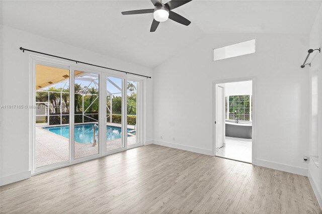 477 Spinnaker, Weston, FL 33326 - unfurnished room with wood finished floors, a ceiling fan, baseboards, and high vaulted ceiling