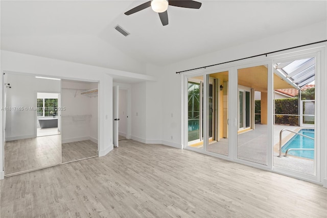 477 Spinnaker, Weston, FL 33326 - unfurnished bedroom with access to outside, wood finished floors, vaulted ceiling, baseboards, and a ceiling fan