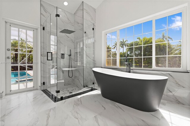 477 Spinnaker, Weston, FL 33326 - full bath featuring a freestanding bath, a marble finish shower, and marble tiled flooring