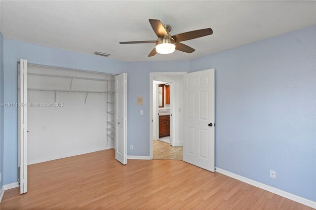 477 Spinnaker, Weston, FL 33326 - unfurnished bedroom featuring light wood-style flooring, a closet, baseboards, and a ceiling fan