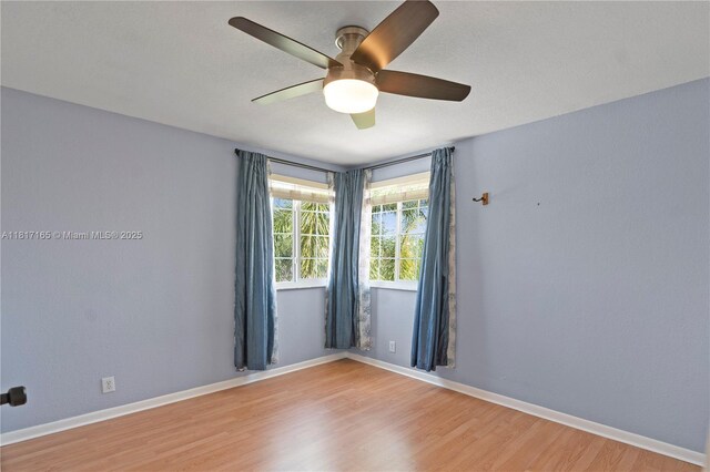 477 Spinnaker, Weston, FL 33326 - spare room with light wood finished floors, a ceiling fan, and baseboards