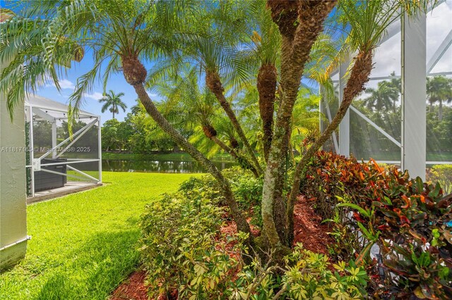 477 Spinnaker, Weston, FL 33326 - view of grassy yard with a water view and glass enclosure