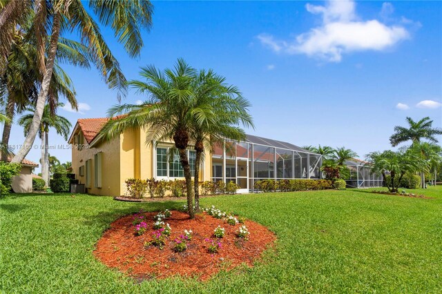 477 Spinnaker, Weston, FL 33326 - view of green lawn with glass enclosure and central AC
