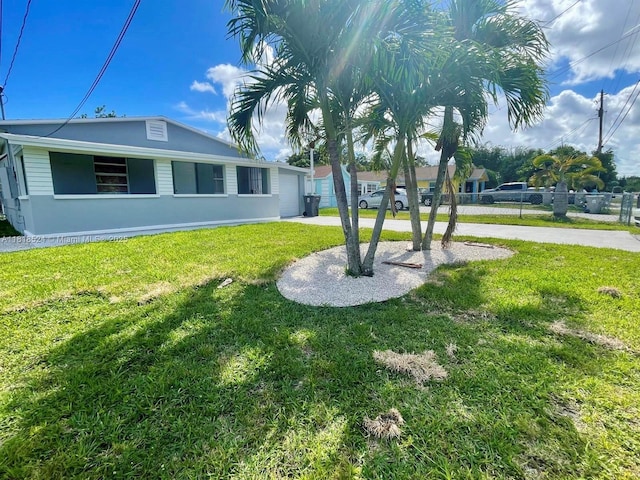 4562 Old Military Trl, West Palm Beach, FL 33417 - view of yard with a garage and driveway