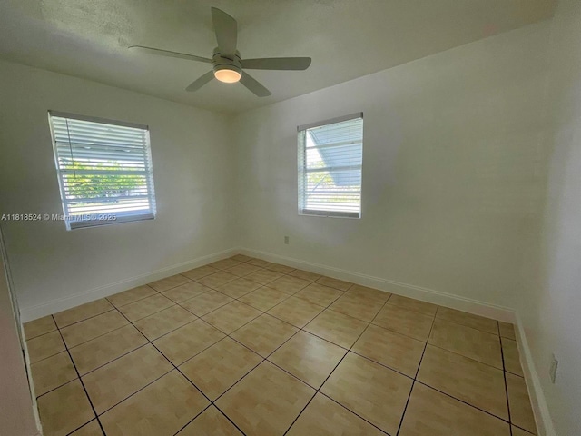 4562 Old Military Trl, West Palm Beach, FL 33417 - spare room featuring light tile patterned floors, healthy amount of natural light, a ceiling fan, and baseboards