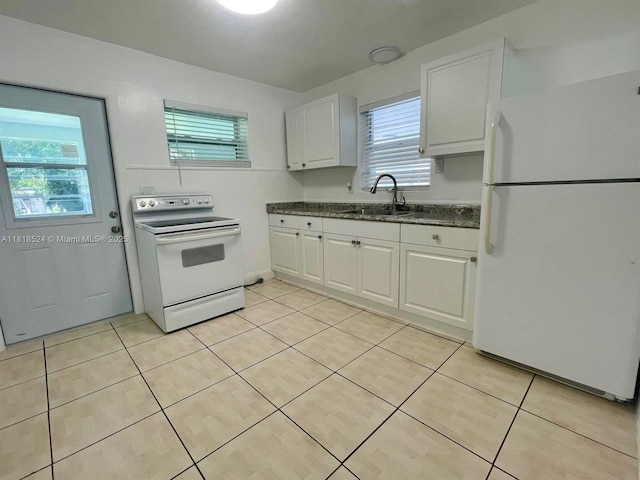 4562 Old Military Trl, West Palm Beach, FL 33417 - kitchen featuring white appliances, a sink, white cabinetry, light tile patterned flooring, and dark stone countertops