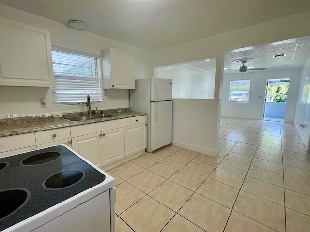 4562 Old Military Trl, West Palm Beach, FL 33417 - kitchen with white appliances, a sink, light tile patterned floors, white cabinets, and a ceiling fan