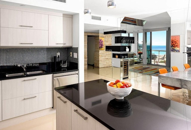 101 20 Unit 2802/2804, Miami Beach, FL 33139 - kitchen featuring a sink, wine cooler, decorative backsplash, open floor plan, and dark countertops