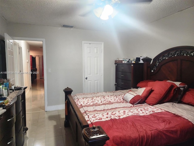 8409 N Missionwood Cir Unit D-30, Miramar, FL 33025 - bedroom featuring a textured ceiling, tile patterned flooring, a ceiling fan, and baseboards