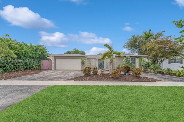 1305 N 47th Ave, Hollywood, FL 33021 - view of front of home with stucco siding, driveway, a front lawn, and a garage