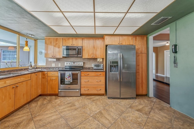 1305 N 47th Ave, Hollywood, FL 33021 - kitchen featuring stainless steel appliances, tasteful backsplash, and dark stone countertops