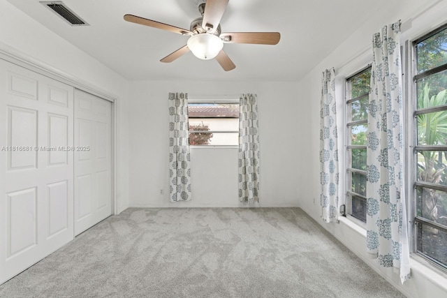 1305 N 47th Ave, Hollywood, FL 33021 - unfurnished bedroom featuring carpet flooring, multiple windows, a closet, and a ceiling fan