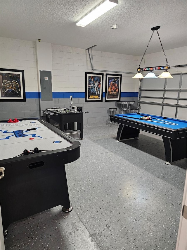 2496 Rama Dr, Kissimmee, FL 34746 - recreation room featuring electric panel, billiards table, a textured ceiling, a garage, and concrete block wall