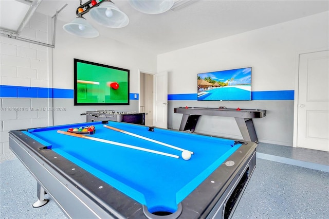 2496 Rama Dr, Kissimmee, FL 34746 - playroom with speckle patterned floor, billiards table, and concrete block wall