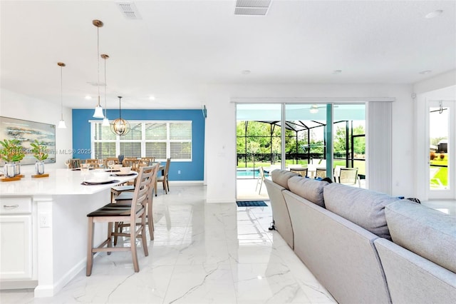 2496 Rama Dr, Kissimmee, FL 34746 - living area with light marble finish flooring, recessed lighting, and a sunroom
