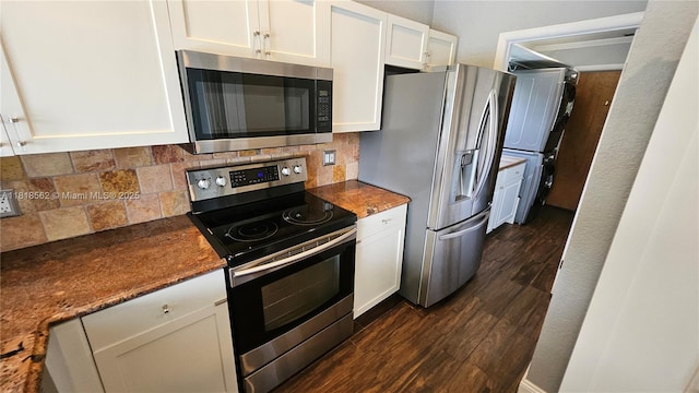 9480 NW 10th St, Plantation, FL 33322 - kitchen featuring appliances with stainless steel finishes, stacked washer / drying machine, white cabinets, dark wood-type flooring, and backsplash