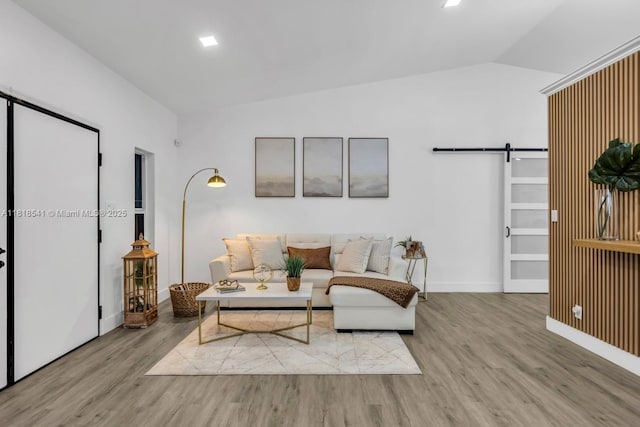 11400 NW 27th St, Plantation, FL 33323 - living room with vaulted ceiling, a barn door, wood finished floors, and baseboards