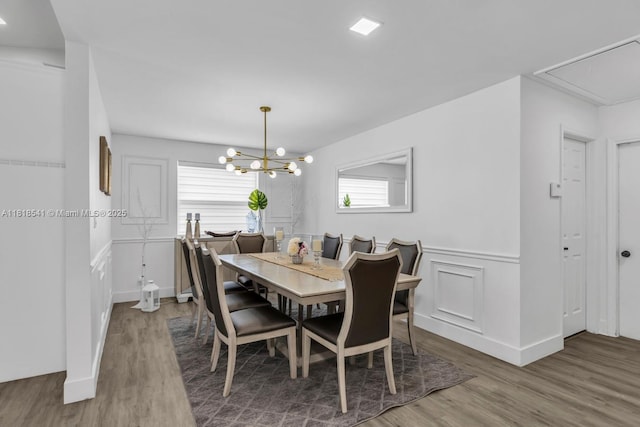 11400 NW 27th St, Plantation, FL 33323 - dining space with wood finished floors, a chandelier, attic access, a wainscoted wall, and a decorative wall