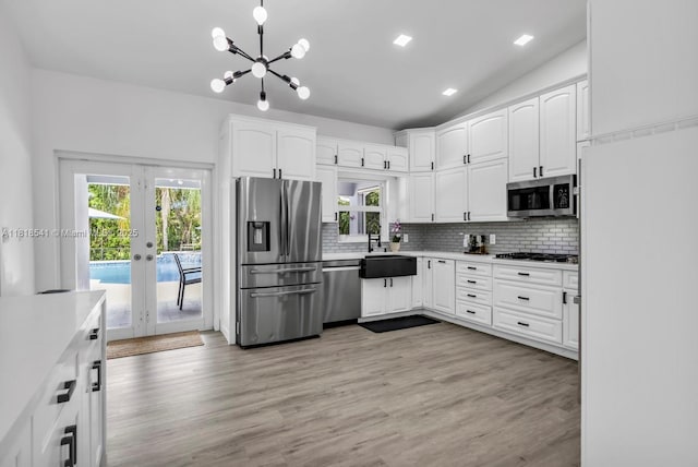 11400 NW 27th St, Plantation, FL 33323 - kitchen featuring stainless steel appliances, a sink, french doors, healthy amount of natural light, and lofted ceiling
