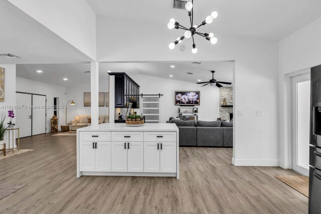 11400 NW 27th St, Plantation, FL 33323 - kitchen with open floor plan, light wood-type flooring, vaulted ceiling, light countertops, and ceiling fan