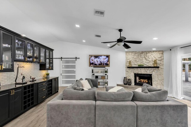 11400 NW 27th St, Plantation, FL 33323 - living room featuring wet bar, a ceiling fan, a stone fireplace, light wood-type flooring, and recessed lighting