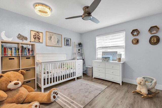 11400 NW 27th St, Plantation, FL 33323 - bedroom featuring a nursery area, wood finished floors, baseboards, and ceiling fan