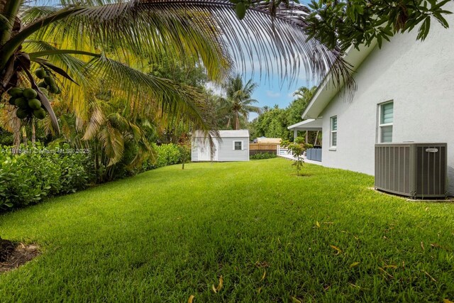 11400 NW 27th St, Plantation, FL 33323 - view of grassy yard featuring cooling unit and an outbuilding
