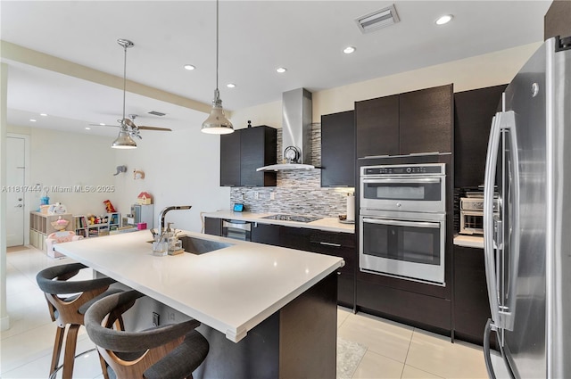 10540 NW 63rd Ter, Doral, FL 33178 - kitchen featuring a sink, stainless steel appliances, wall chimney range hood, light tile patterned floors, and light countertops