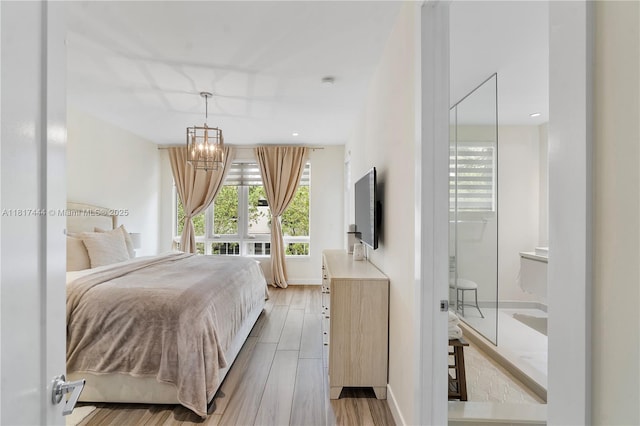 10540 NW 63rd Ter, Doral, FL 33178 - bedroom with a chandelier, light wood-type flooring, and baseboards
